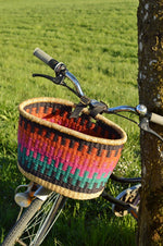 colorful bolga bike basket attached to the bike handle