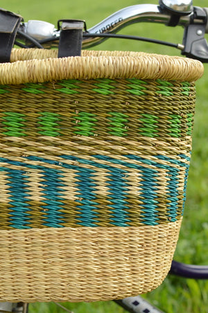 
                  
                    green-blue-natural bolga bike basket attached to bike handle
                  
                