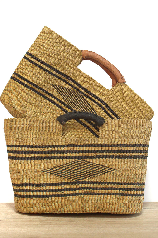 
                  
                    two natural and black bolga rectangular handgas with leather straps
                  
                