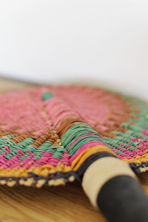 
                  
                    close up of a pastel colored round bolga fan
                  
                