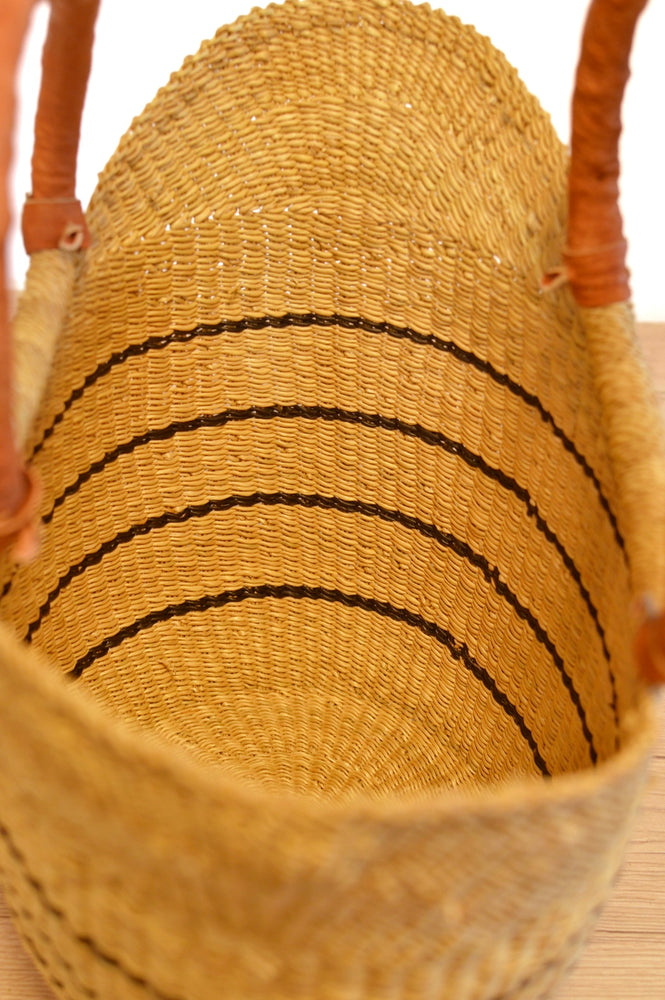 
                  
                    straw striped basket with brown leather handles 
                  
                
