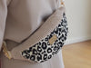 a short video of an European woman wearing a leopard textured fanny pack as a crossbody bad made by Afrikatja