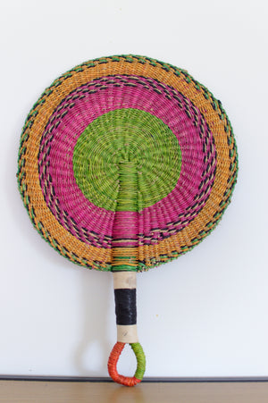 
                  
                    pastel colored round bolga fan leaned on a white background
                  
                