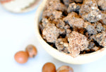 black soap crumbles in a calabash wih shea nuts in front