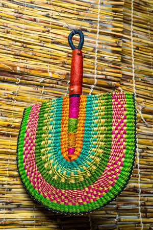 
                  
                    colorful bolga fan with leather handle on a bamboo blinds
                  
                