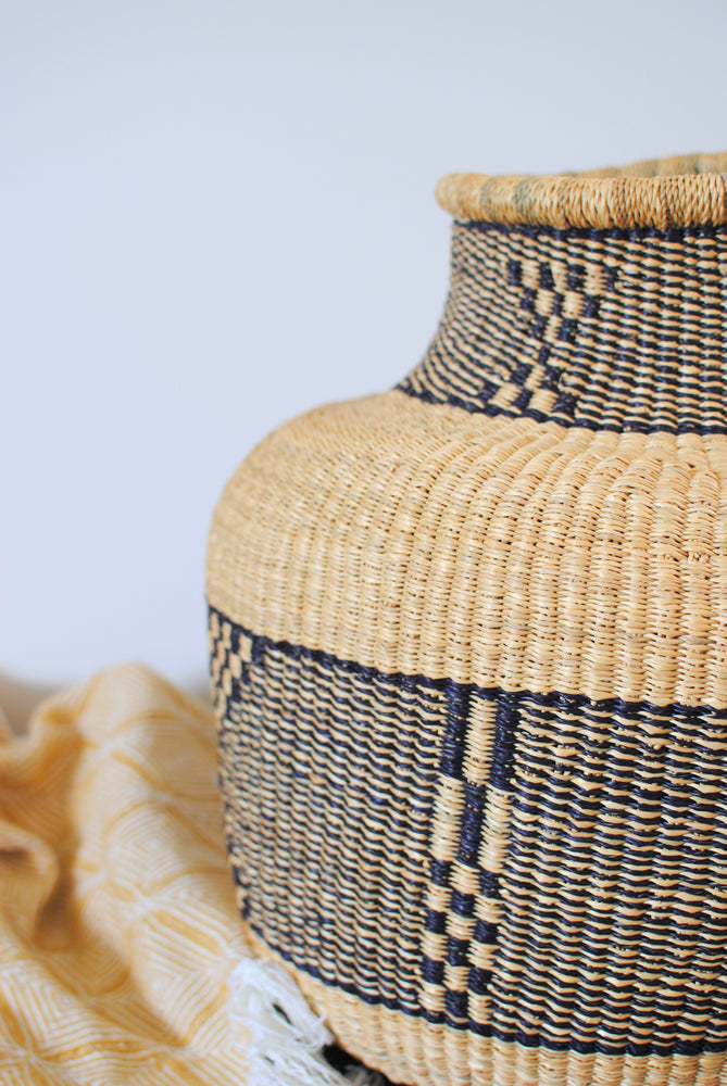 a large vase basket from elephant grass with a geometric pattern