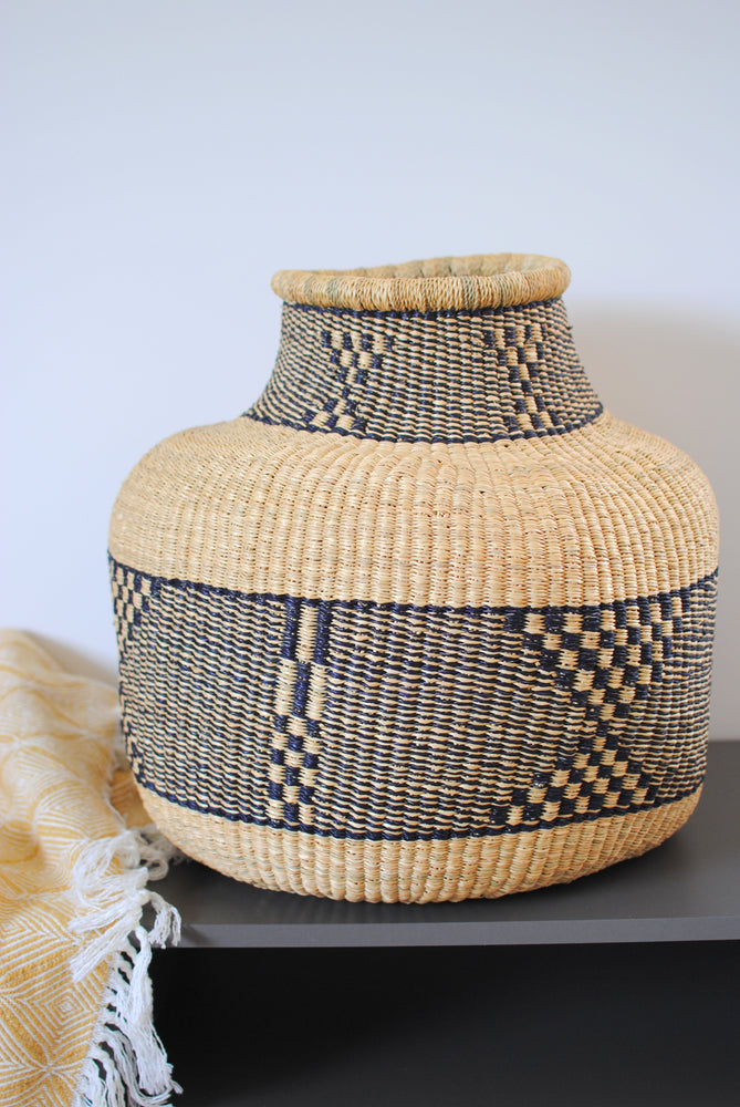 a large vase basket from elephant grass with a geometric pattern