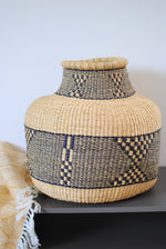 a large vase basket from elephant grass with a geometric pattern