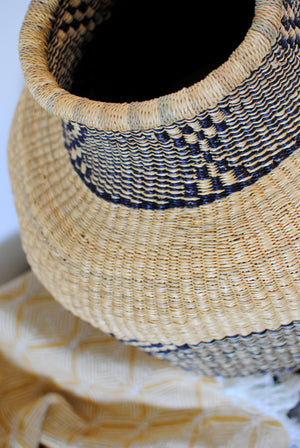 
                  
                    a large vase basket from elephant grass with a geometric pattern
                  
                